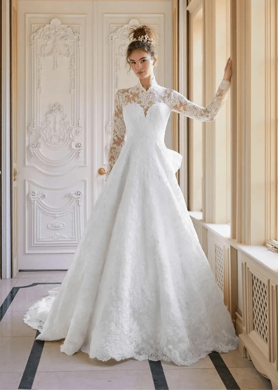 Sareh Nouri Now and Forever Wedding Dress - Long Sleeve Lace Ball Gown with High Neckline and Bow - Size 12 - Luxe Redux Bridal Sareh Nouri Now and Forever Wedding Dress - Long Sleeve Lace Ball Gown with High Neckline and Bow - Size 12 - Luxe Redux Bridal