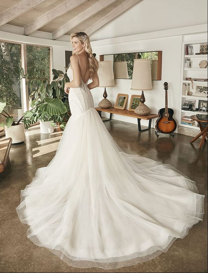 full back of beloved by casablanca ivory tulle fit and flare wedding dress featuring a beaded bodice and flared tulle skirt with a long train