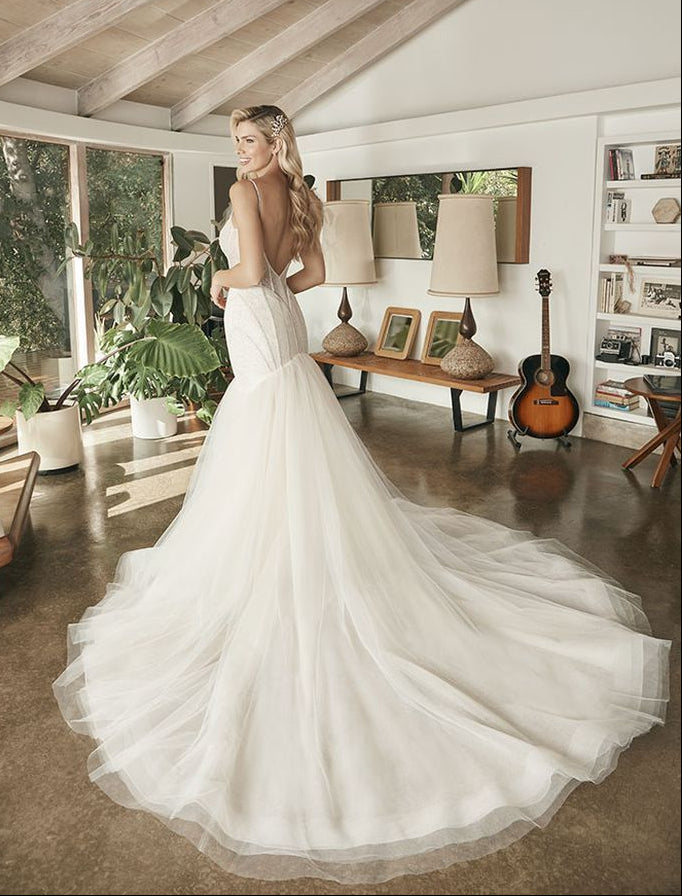 full back of beloved by casablanca ivory tulle fit and flare wedding dress featuring a beaded bodice and flared tulle skirt with a long train