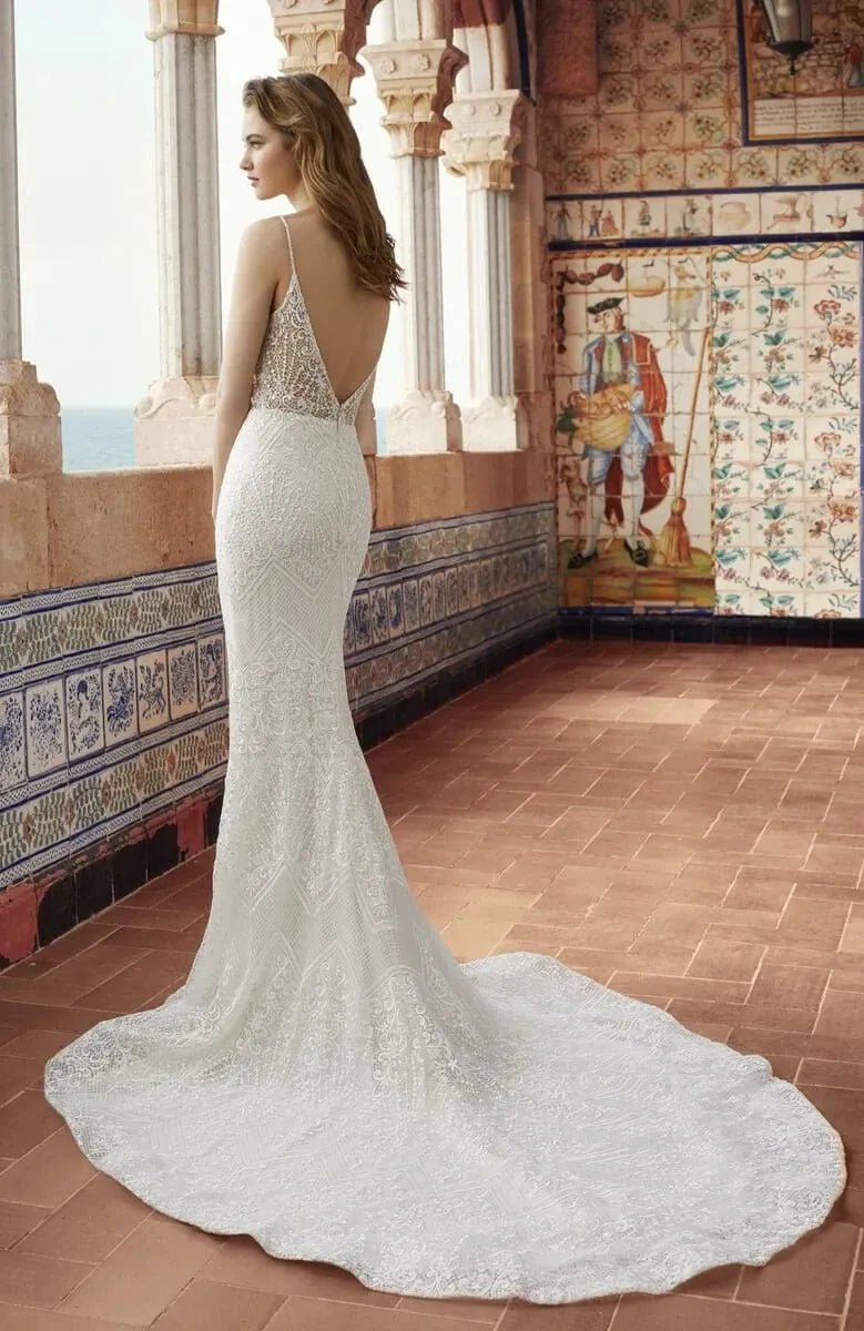 abella lace fit and flare wedding dress showing the back of the gown, with a deep V back and shaped chapel length train