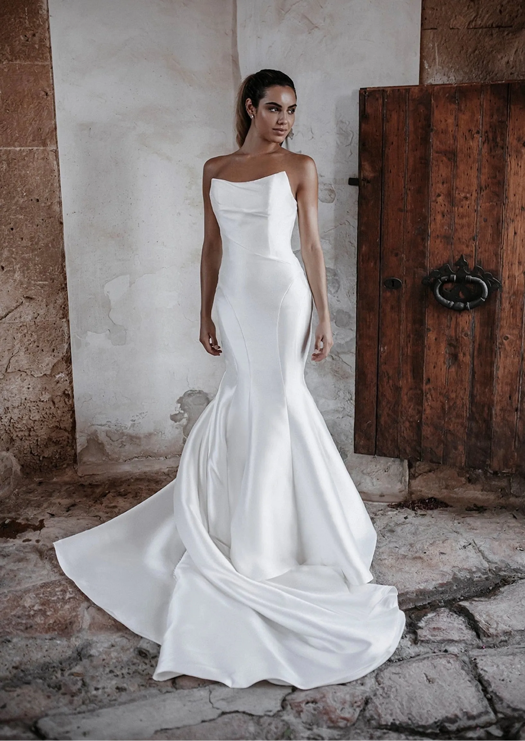 front of abella e215 ivory mikado fitted wedding dress with strapless scoop neckline, flared skirt, and long train