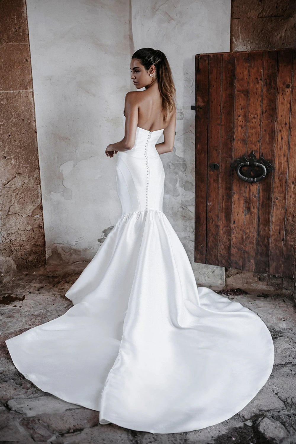 back of abella e215 ivory mikado fitted wedding dress with buttons down the back of the bodice and long train