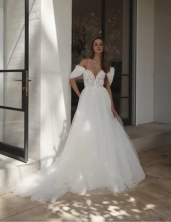 full front of alena leena clivia ivory tulle a-line wedding dress with a sweetheart neckline and detachable straps