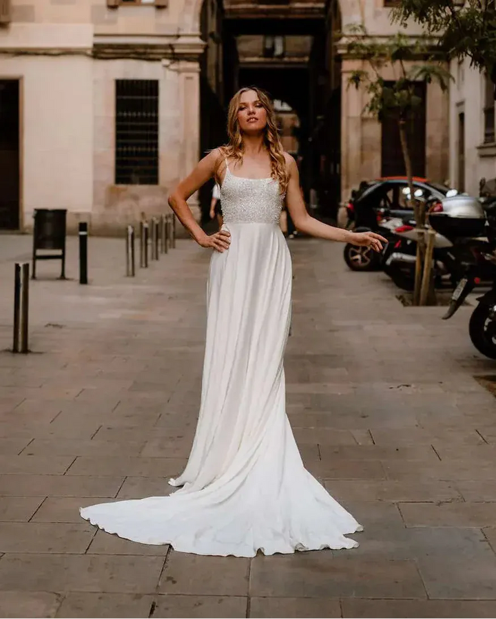 Woman in a white dress standing on a street with 'Passage de la Paz' in the background