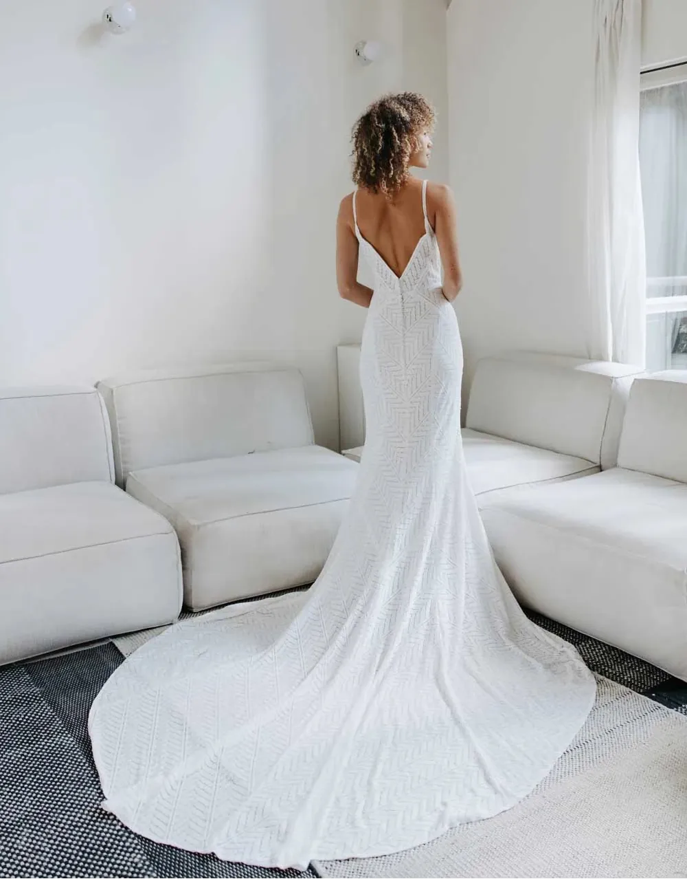 full back of all who wander archer ivory lace fit and flare wedding dress with a geometric pattern and chapel length neckline