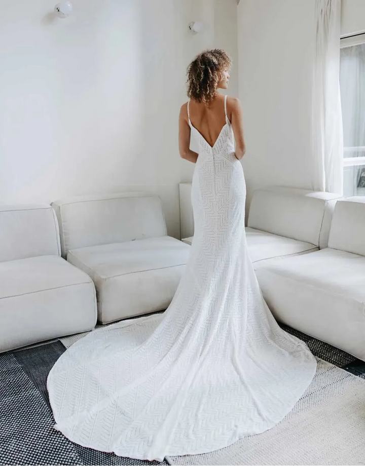 full back of all who wander archer ivory lace fit and flare wedding dress with a geometric pattern and chapel length neckline