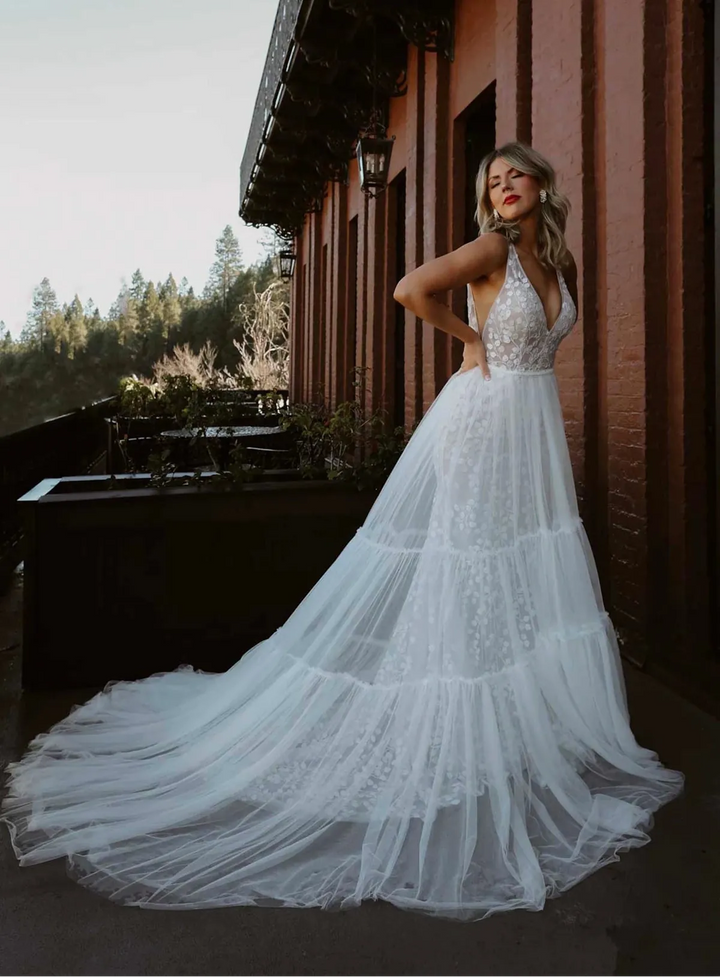 full front of all who wander cece ivory lace fitted wedding dress with the matching tulle overskirt