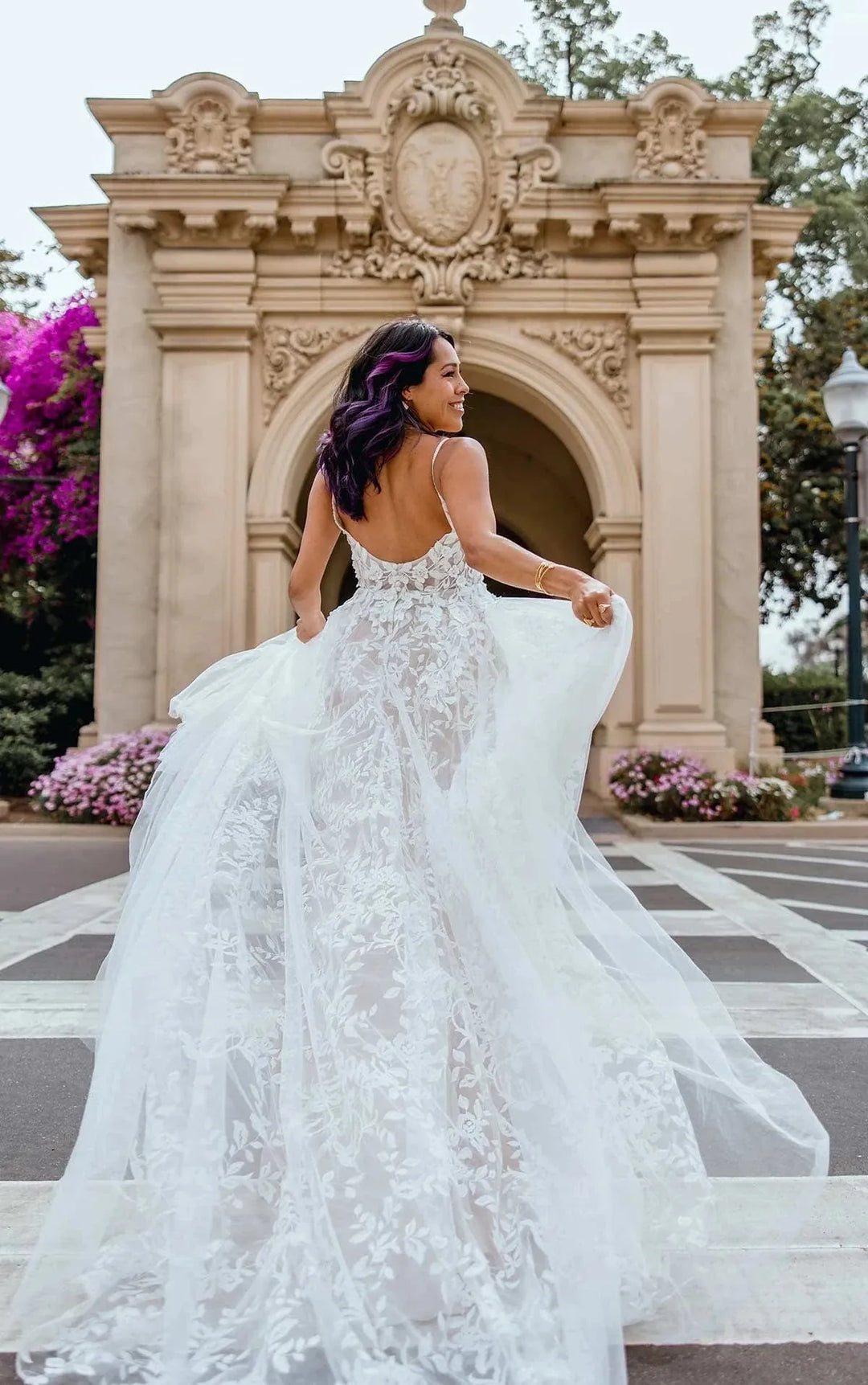 back of all who wander haven champagne tulle a-line wedding dress with a sheer floral skirt and flowy train