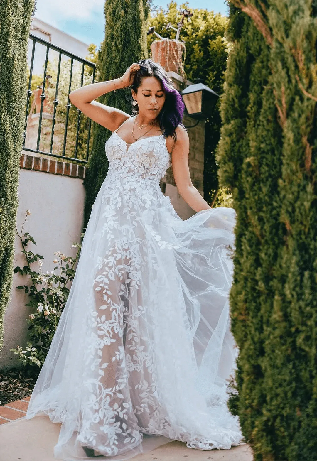 front of all who wander haven champagne tulle a-line wedding dress with a v neckline and sheer floral skirt