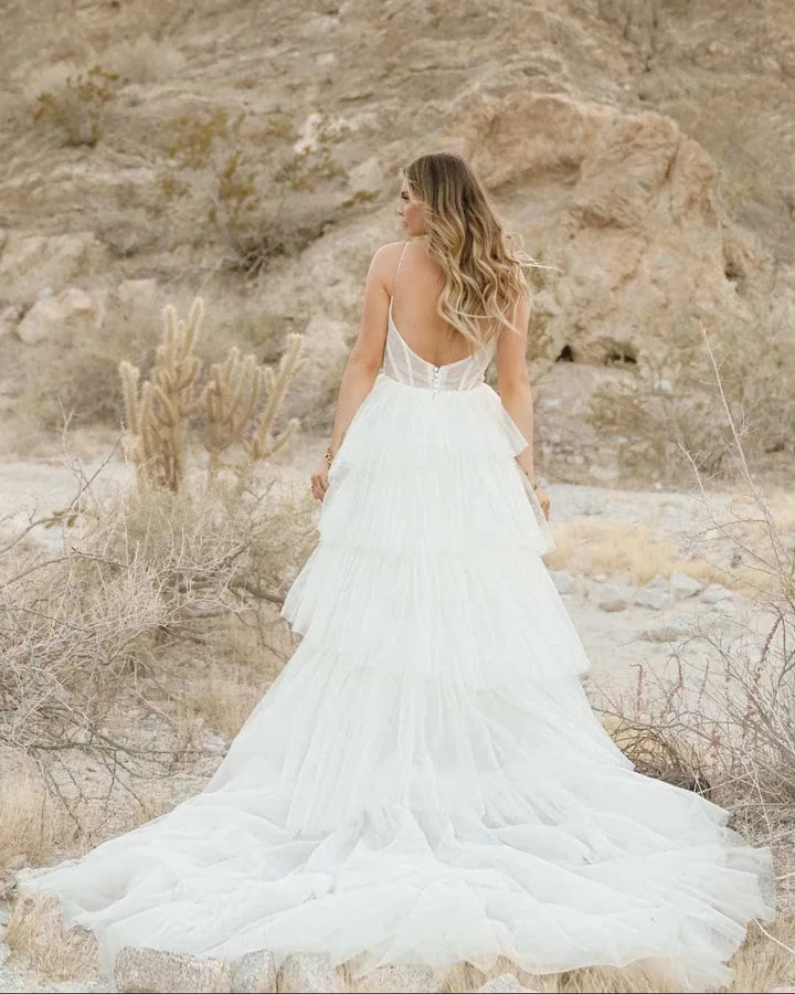 full back of all who wander jasper ivory tulle ball gown wedding dress with tiered skirt and detailed bodice, finished with a short train