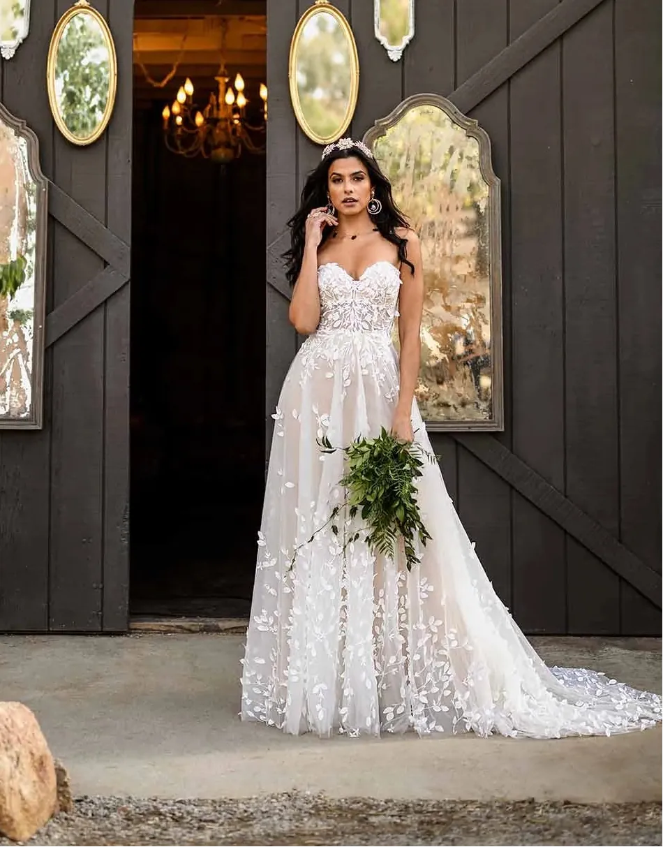 Woman in a wedding dress standing in front of a rustic wooden door with mirrors and antlers.
