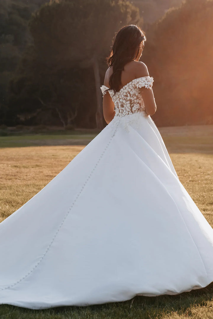 back of allure 9908 ivory satin a-line wedding dress with floral lace appliques on the bodice and a chapel length train
