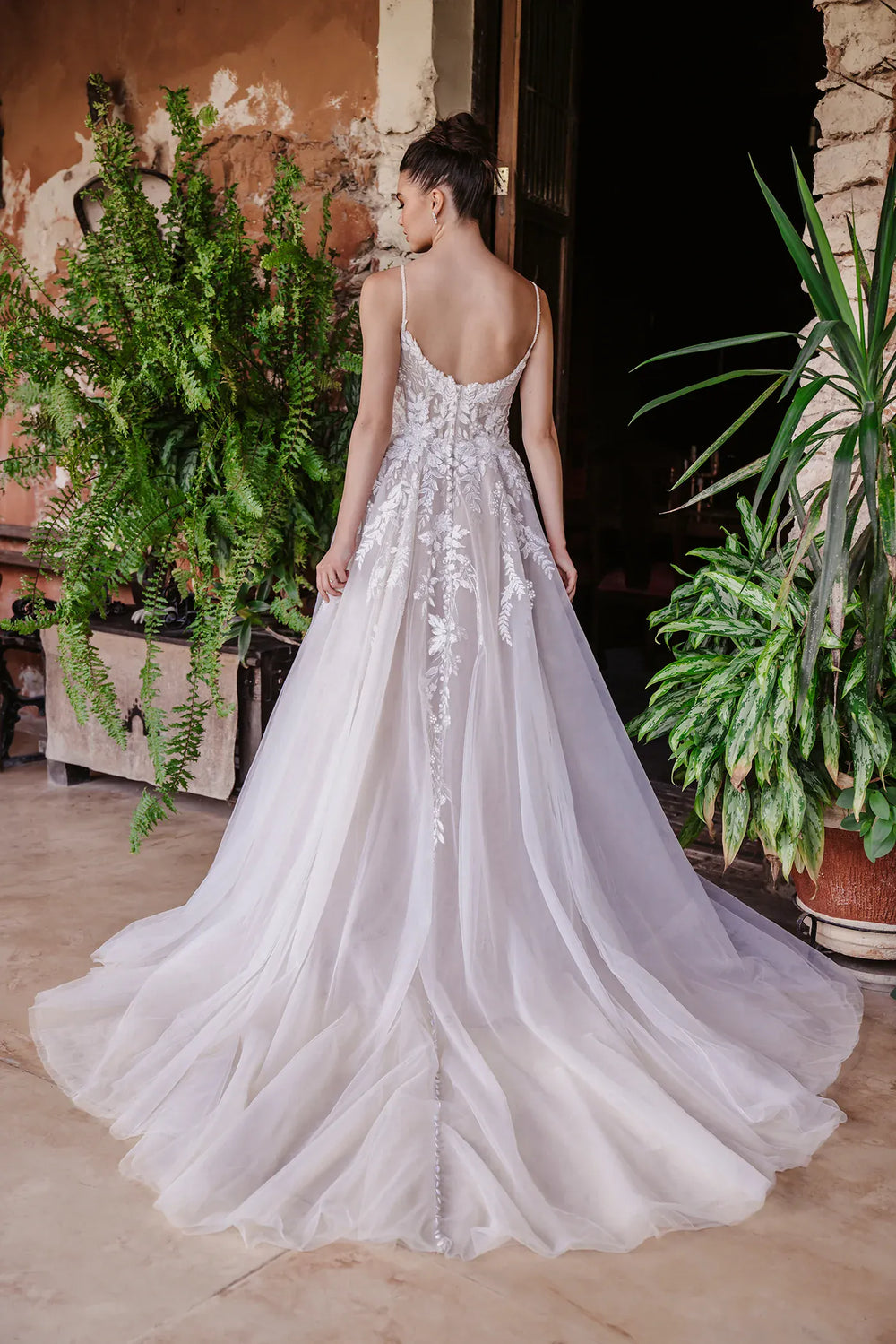 full back of allure 9951 mocha tulle a-line wedding dress featuring an open back, cascading floral lace appliques, and a chapel length train