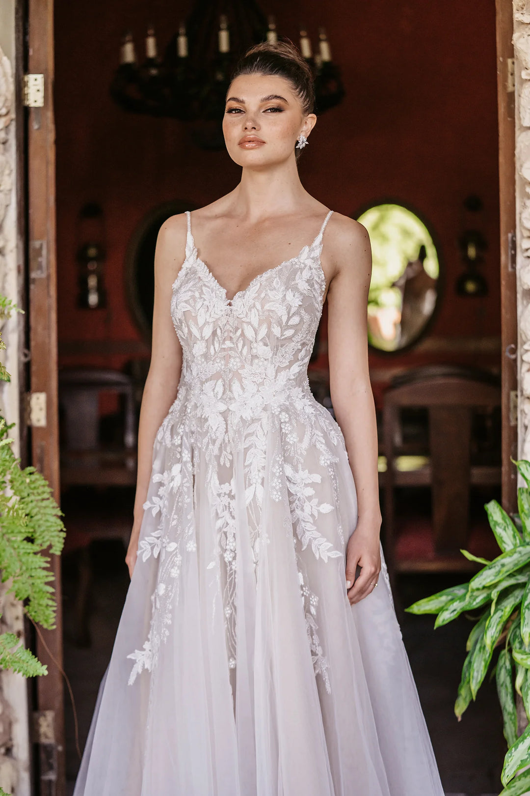 close up of allure 9951 mocha tulle a-line wedding dress showing the v neck bodice with thin straps and cascading floral lace appliques