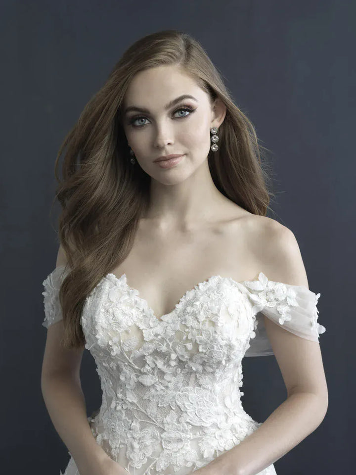 Woman wearing a white off-shoulder dress against a dark background