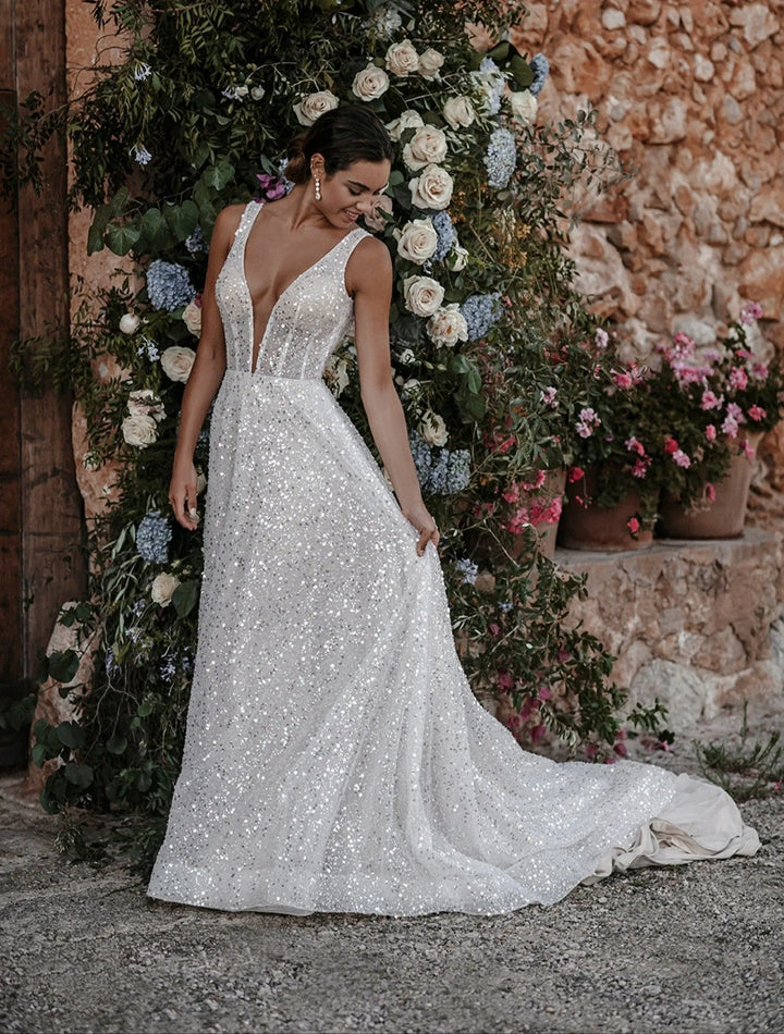 full front of abella e214 ivory a-line wedding dress of allover sequins, with a plunge neckline