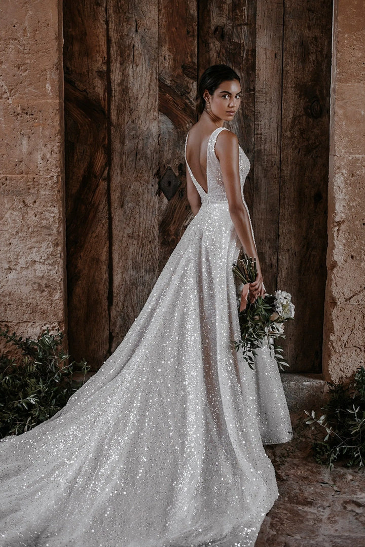 full back of abella e214 ivory a-line wedding dress of allover sequins, with a plunge neckline and chapel length train