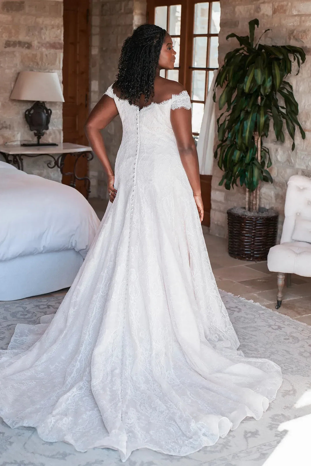 full back of allure w501 nude lace a-line wedding dress featuring a detailed lace pattern and chapel length train