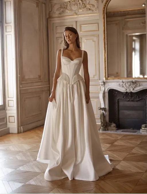 full front of alon livne charlotte ivory mikado bridal set with a full skirt and corset top, with a peplum accent