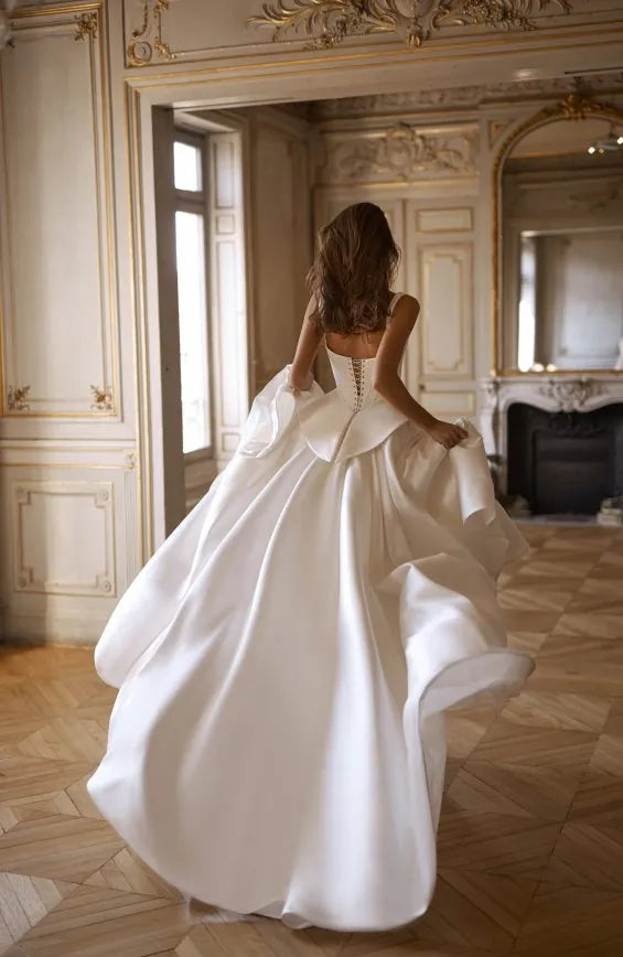 full back of alon livne charlotte ivory mikado bridal set with a full skirt and corset top, with a peplum accent