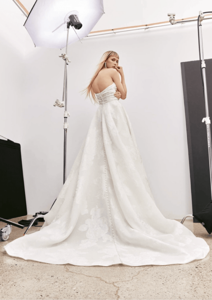 full back of alyne pixie ivory jacquard a-line wedding dress with a strapless straight neckline and floral print, finished with a chapel length train