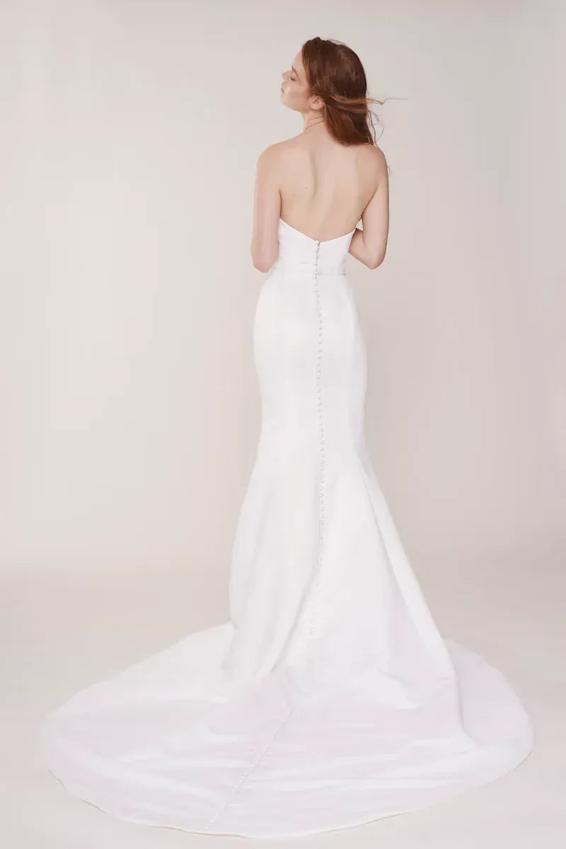 full back of alyne windsor ivory satin fit and flare wedding dress with a notched v neckline