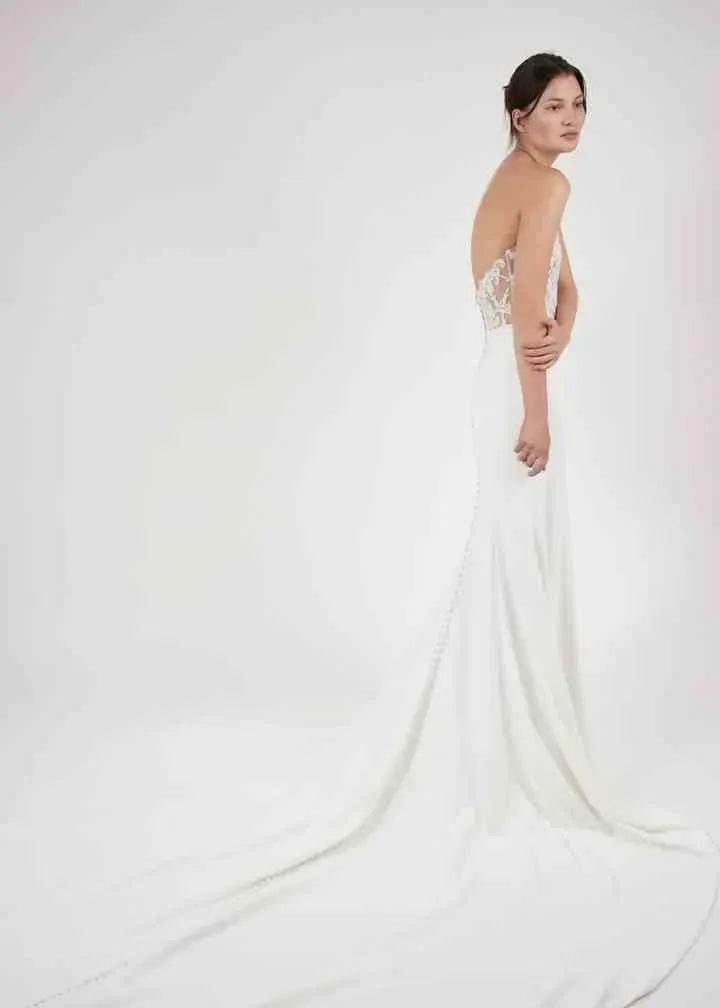 full back of alyne zadye ivory crepe fitted wedding dress with a lace applique bodice