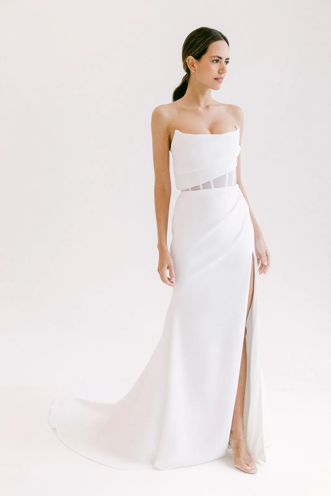 full front of alyssa kristin aria crepe ivory fitted wedding dress with a cat eye bodice and skirt slit