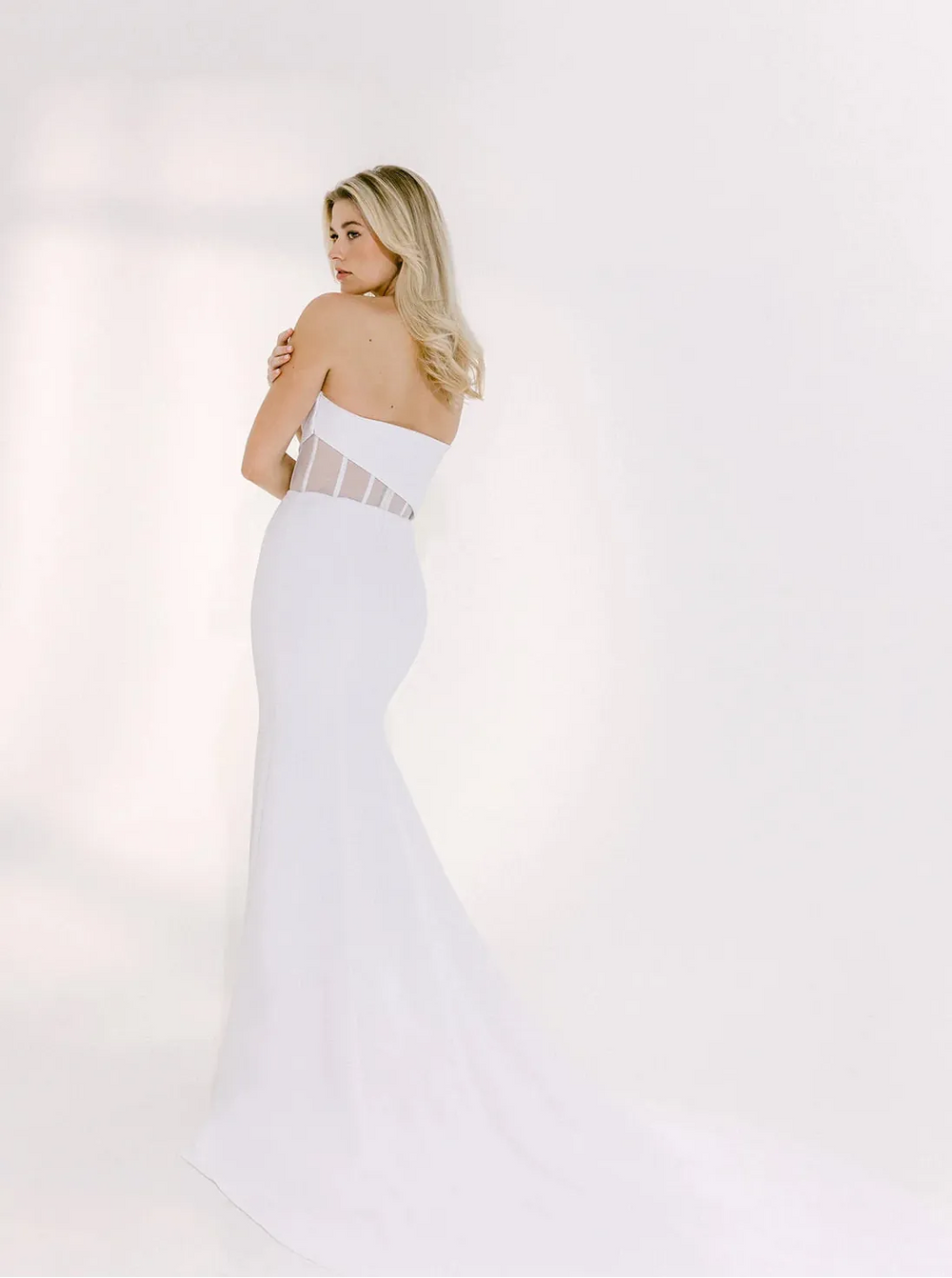 full back of alyssa kristin aria crepe ivory fitted wedding dress showing the sheer back and short train