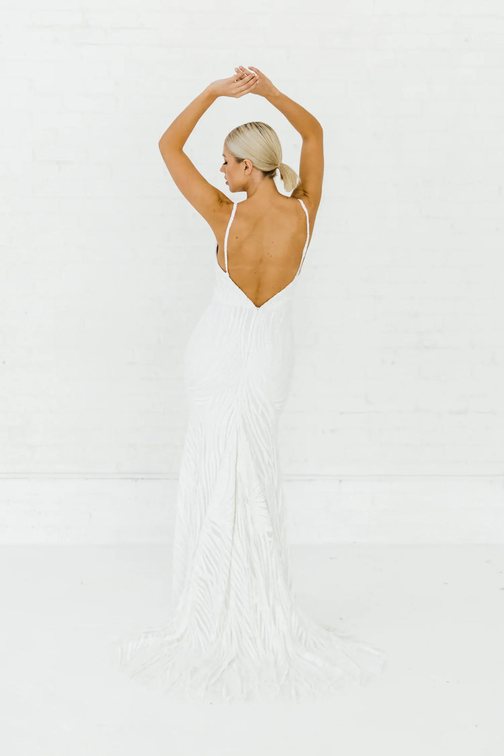 full back of alyssa kristin hadley ivory beaded fitted wedding dress with a plunging neckline