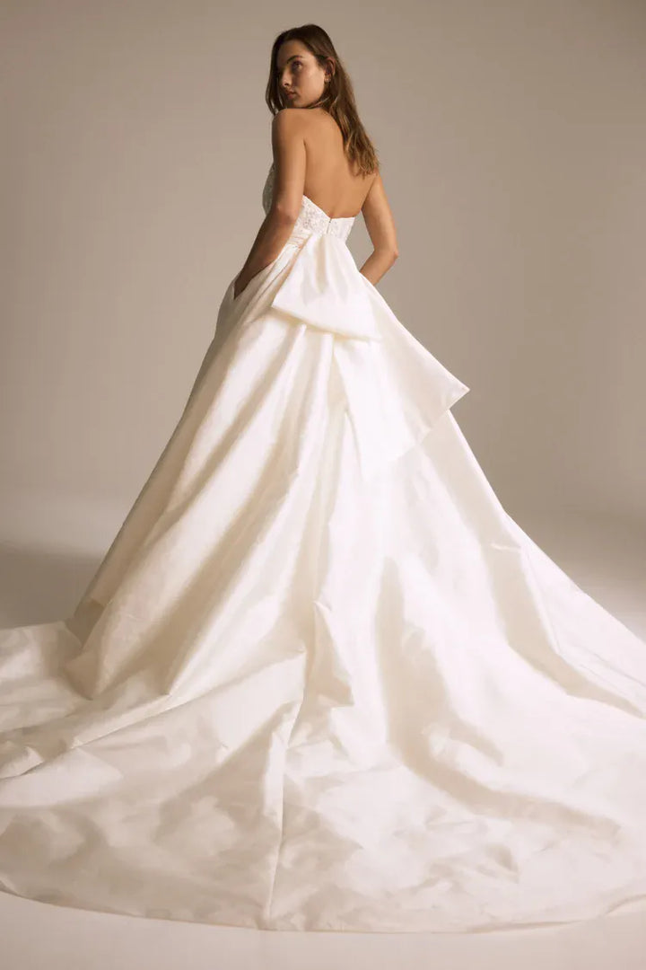 back of amsale pepper ivory taffeta ball gown wedding dress with an oversized bow at the back