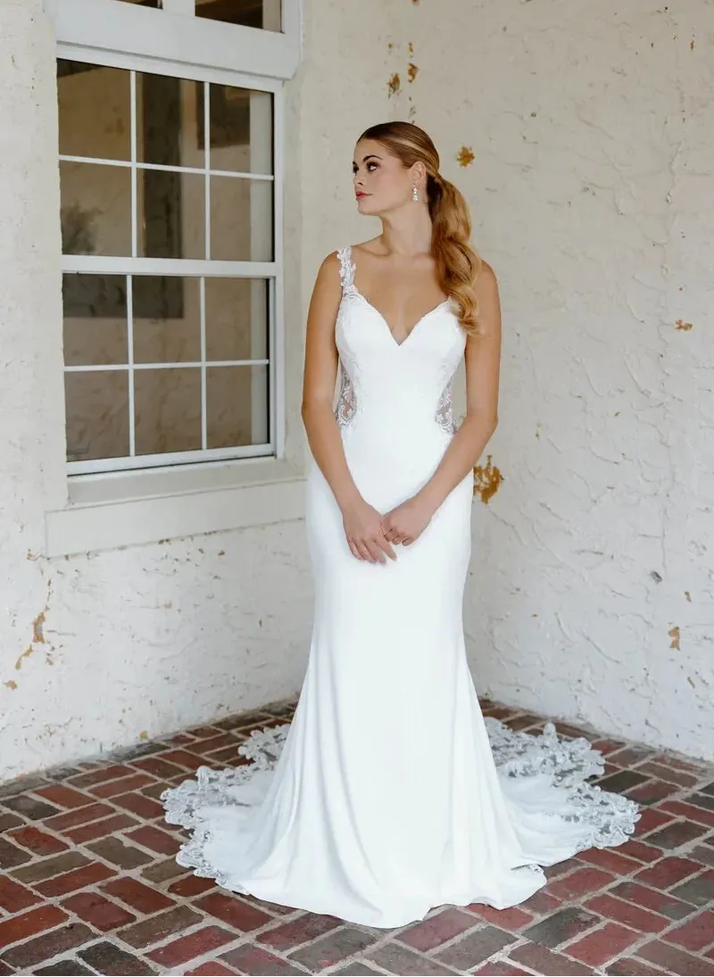 full front of angel rivera hibiscus crepe sheath wedding dress with lace appliques and a shaped lace train