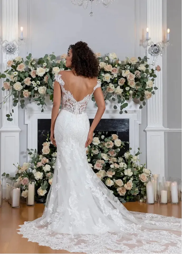 full back of flores by angel rivera ivory lace fitted wedding dress with an open back and sheer train