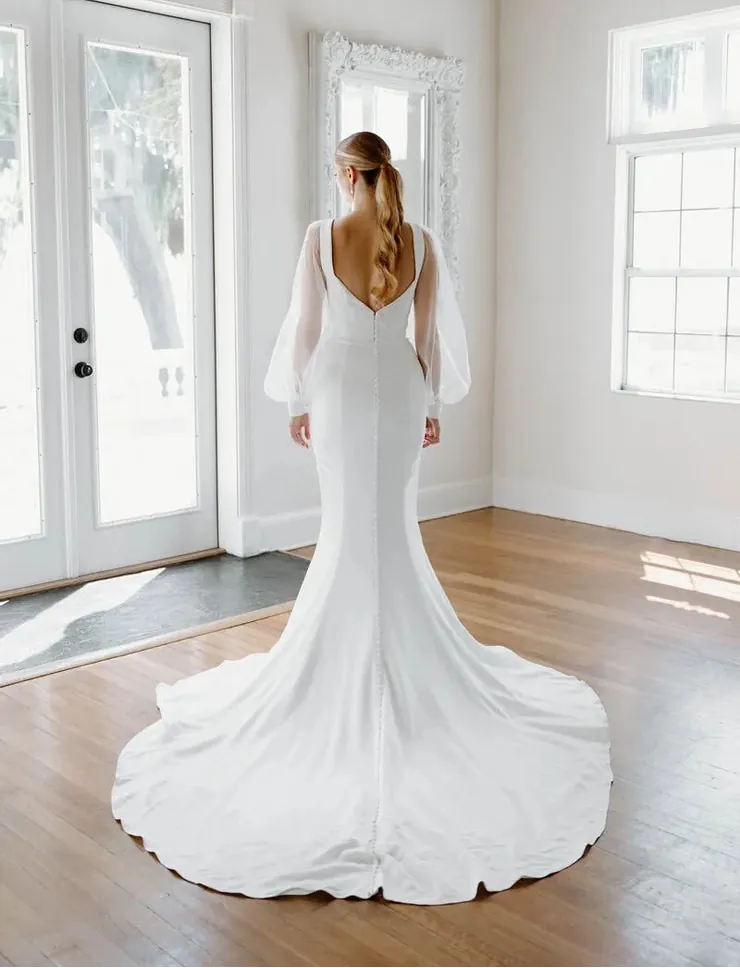 full back of angel rivera viola ivory crepe fitted wedding dress with long flowy sleeves