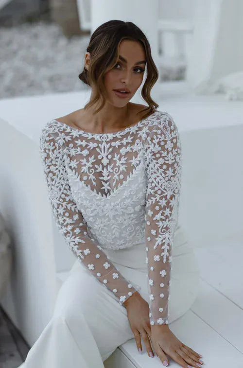 close up of anna campbell lissia ivory lace topper with an illusion neckline and long sleeves