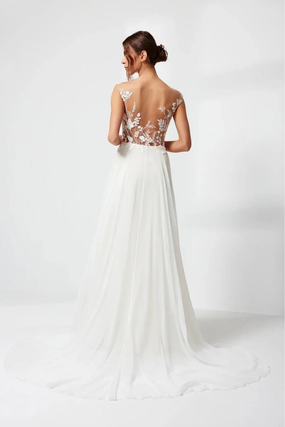 White wedding dress with floral back design on a white background