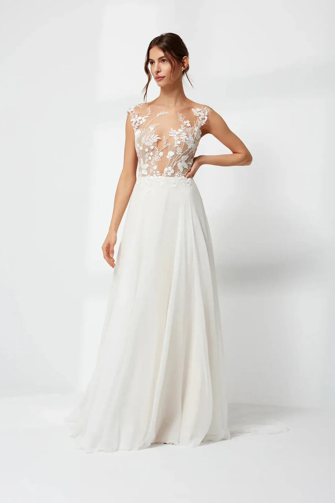White wedding dress with floral lace top on a white background
