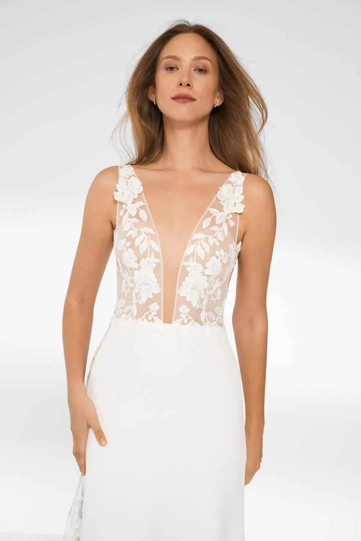 close up of anna kara liana ivory satin sheath wedding dress showing the plunging neckline and sheer lace details
