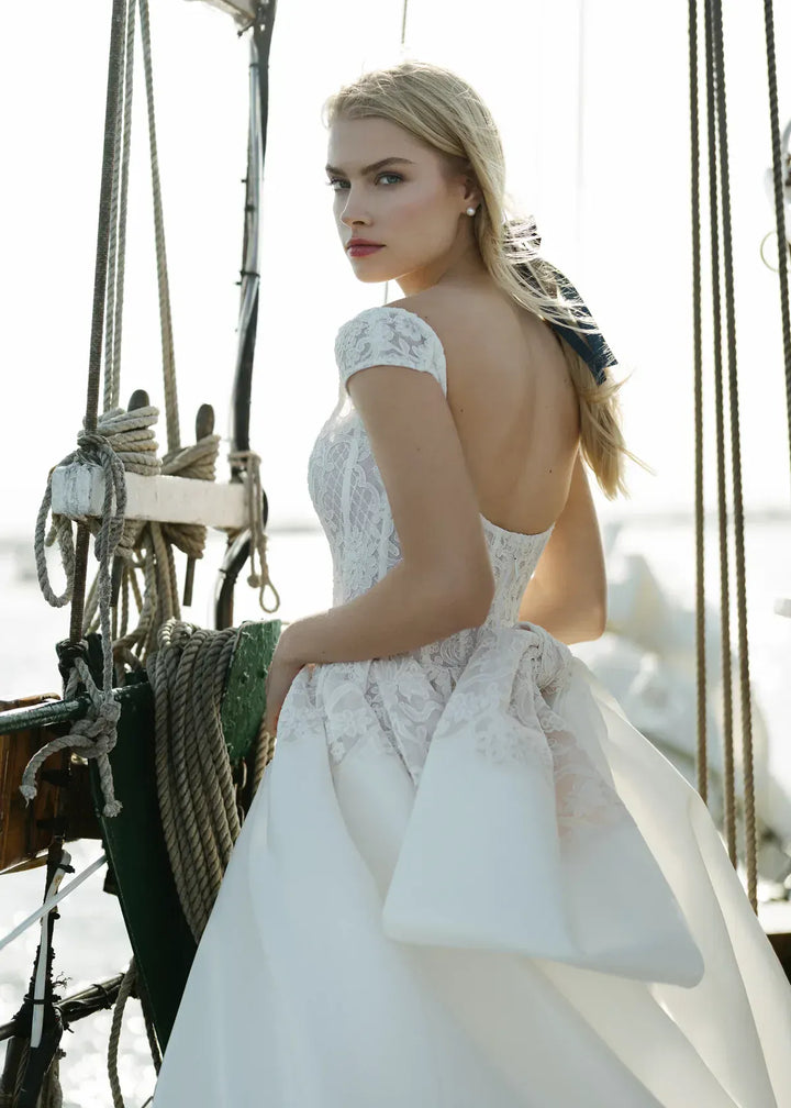 close up of anne barge endeavor ivory silk a-line wedding dress showing the back, with the matching bow