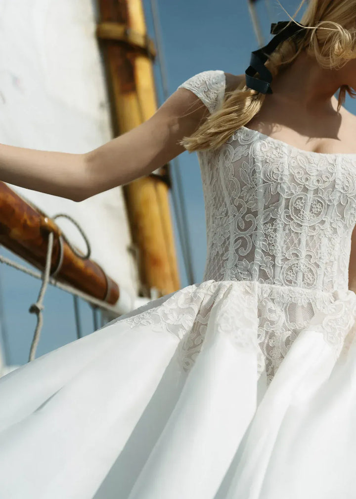 close up of anne barge endeavor ivory silk a-line wedding dress showing the lace bodice with cap sleeves