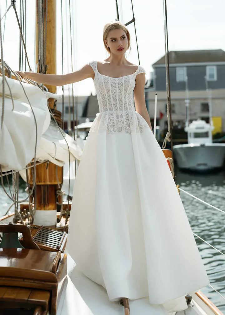 full front of anne barge endeavor ivory silk a-line wedding dress featuring lace details on the bodice and cap sleeves