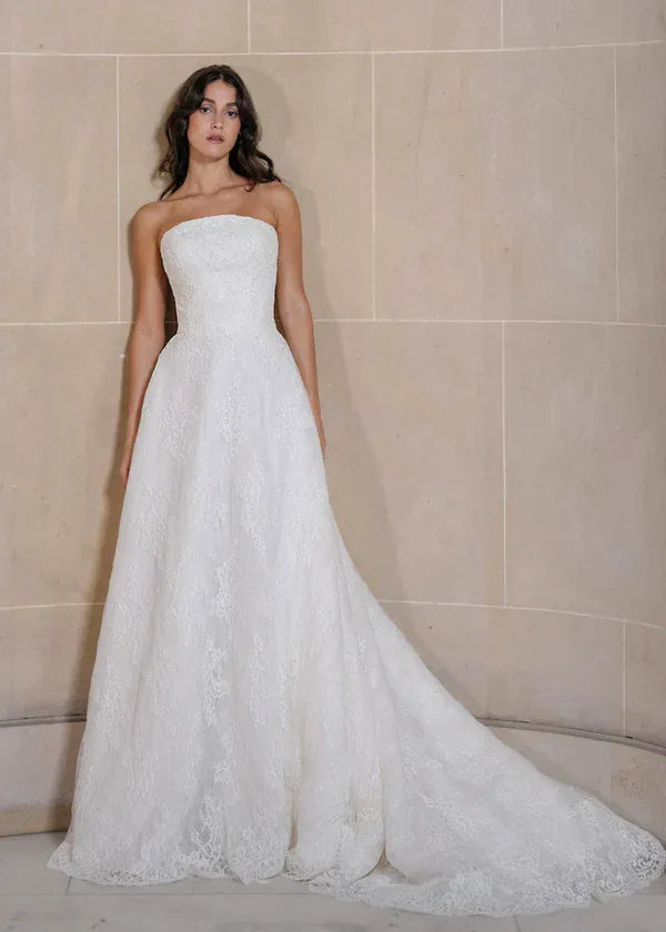 full front of anne barge graham ivory lace a-line wedding dress with a strapless neckline