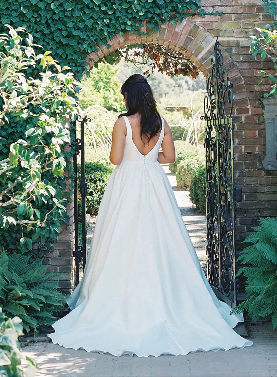 full back of anne barge lucie ivory organza ball gown wedding dress with a v neckline and thick straps