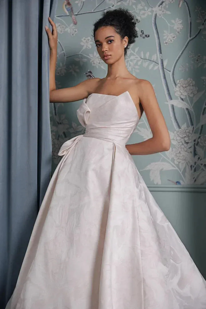 close up of anne barge montecito blush jacquard ball gown wedding dress showing the draping on the strapless bodice 