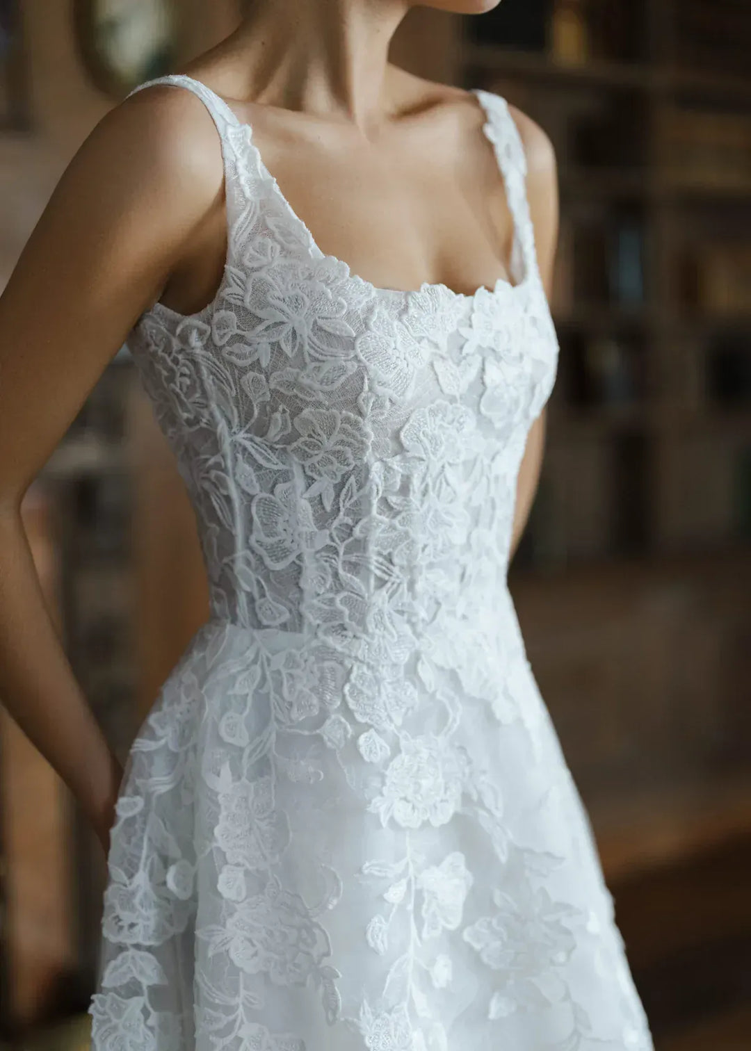close up of anne barge oakland ivory tulle a-line wedding dress with floral lace appliques and a square neckline