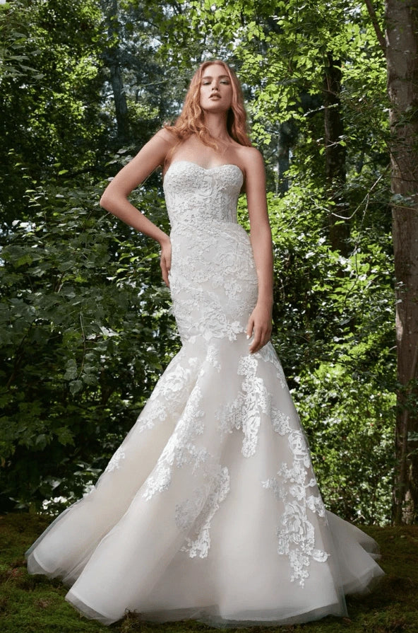 front of anne barge bliss ivory tulle fit and flare wedding dress with lace appliques scattered throughout, without the detached long sleeves