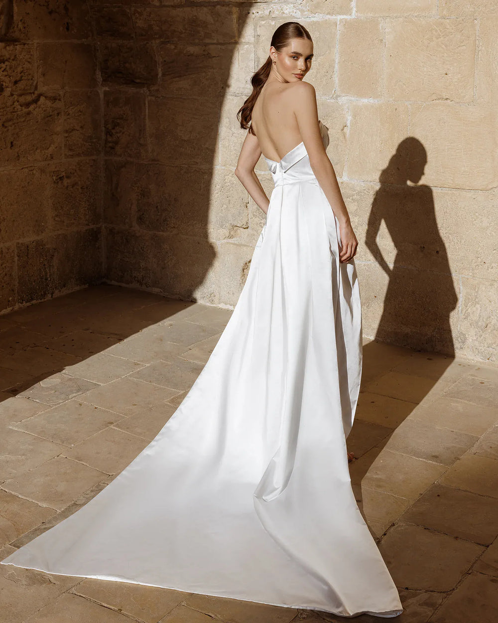 back of antonio gual shelly ivory satin sheath wedding dress showing the full back, with the long shaped train