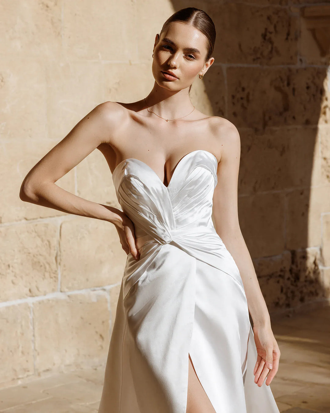 close up of antonio gual shelly ivory satin sheath wedding dress showing the wrap style bodice and sweetheart neckline