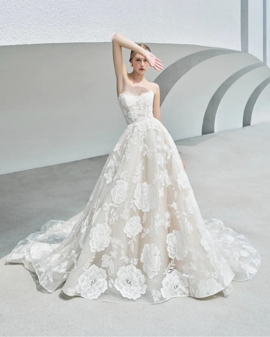 White wedding dress with floral details on a neutral background