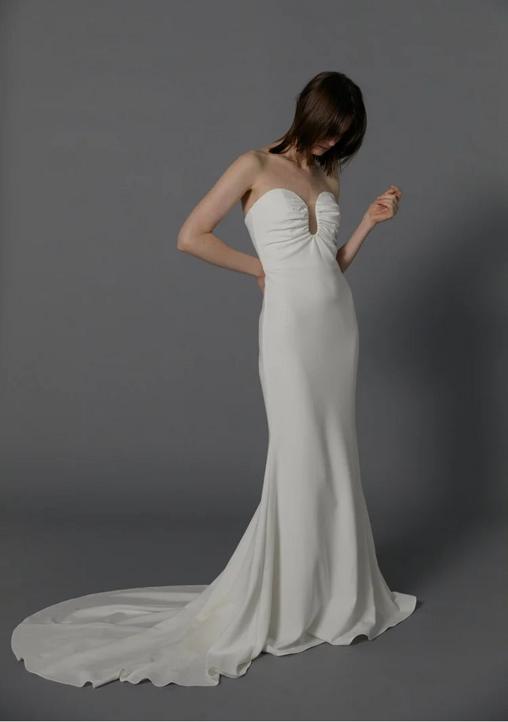 full front of besa bridal andre ivory crepe fitted wedding dress featuring a strapless u neckline and chapel length train